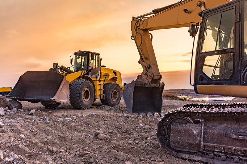 Excavator and wheel loader operating at a construction site